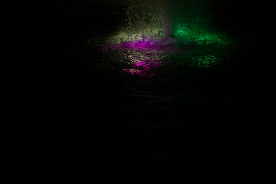 Colored fountain at night. Illumination of water on the fountain. Water in the evening.