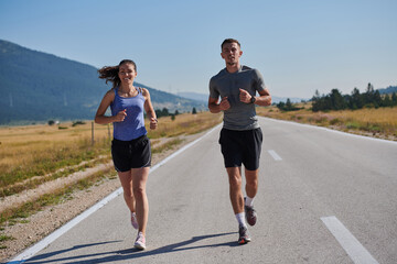 Fototapeta premium Energized by the beauty of nature, a couple powers through their morning run, their bodies and spirits invigorated.