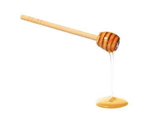 Fotobehang Natural honey dripping from dipper on white background © New Africa