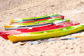 multi-colored canoes on the sand 