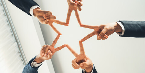 Business people collaborate business synergy and cooperation, join hand as star frame around empty...