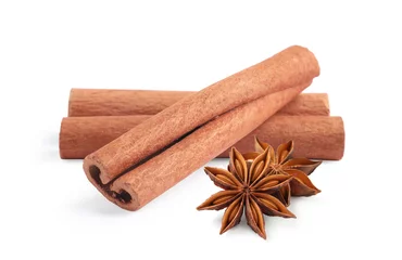 Rolgordijnen Aromatic cinnamon sticks and anise stars isolated on white © New Africa