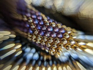 Shiny gold and purple frosted beads close up