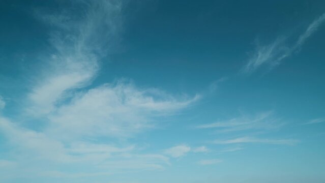 Beautiful cirrus clouds visible in blue sky. Translucent cirrus spindrift clouds high up.