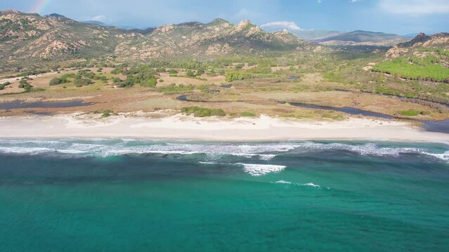 Aerial drone view on white sand Berchida beach of Sardegna. Warm turquoise sea and long beach on the Sardinia island.