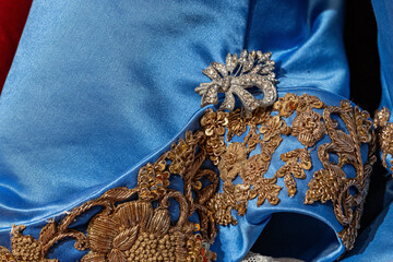 Silver brooch with diamonds on an embellished dress. - obrazy, fototapety, plakaty