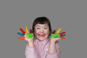 Cute little girl with painted hands. Isolated on grey background. - 757587041