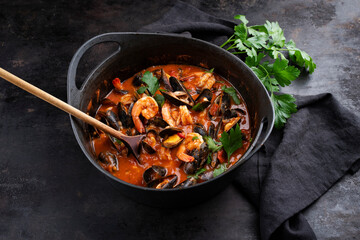Traditional Creole cajun court bouillon with mussels and prawn gumbo chowder stew as close-up in a pot