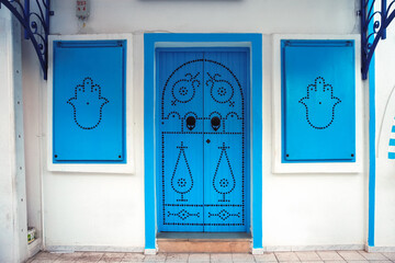 Blue door and window shutters in Houmt Souk city on Djerba Island, Tunisia