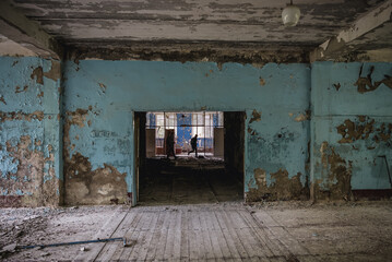 Fototapeta na wymiar Tourists in abandoned Chernobyl-2 military base in Chernobyl Exclusion Zone, Ukraine