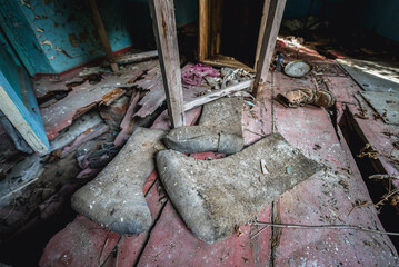 Old boots in abandoned Stechanka village in Chernobyl Exclusion Zone, Ukraine - obrazy, fototapety, plakaty