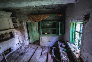 Fototapeta na wymiar Old cottage in abandoned Stechanka village in Chernobyl Exclusion Zone
