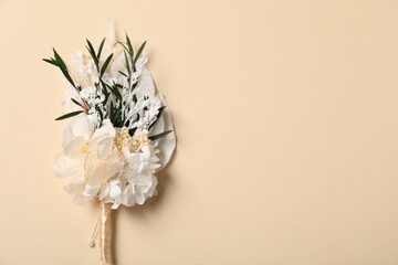 Stylish boutonniere on beige background, top view. Space for text - obrazy, fototapety, plakaty