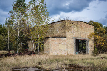 Fototapeta na wymiar Building on wrecking yard near Illinci village in Chernobyl Exclusion Zone, Ukraine