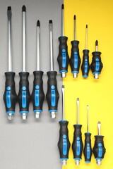 Set of screwdrivers on color background, flat lay