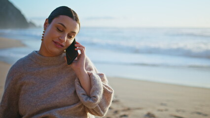 Expectant mother calling walking beach close up. Pregnant woman talking phone