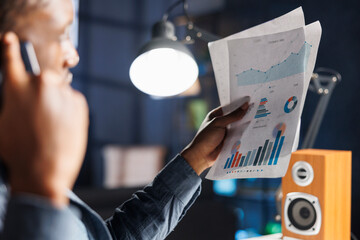 Economic counselor contacts auditor to discuss legal cash processing, financial resources, and cost variables. On phone, african american man addresses capital funds irregularity.