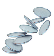 Clean ceramic plates falling on white background