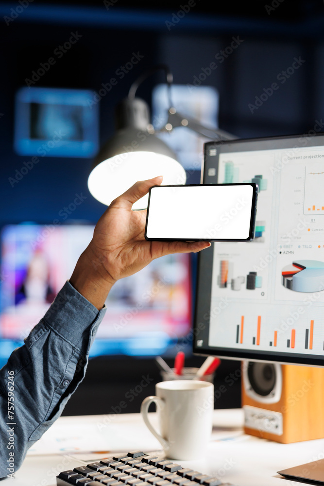 Poster african american man holds device with white screen layout at his home desk, using funds analytics t