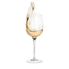 White wine splashing in glass on white background