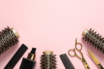 Professional hair dresser tools on pink background, flat lay. Space for text