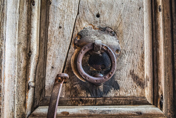 Wooden door with knocker in Church of the Holy Sepulchre in Christian Quarter of Old City of Jerusalem, Israel - obrazy, fototapety, plakaty