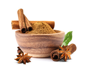 Aromatic cinnamon sticks, powder, anise stars and green leaf isolated on white