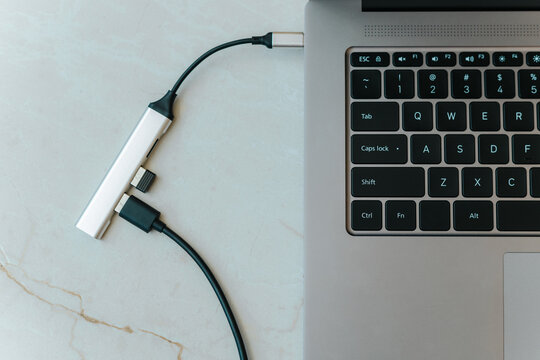 Close up of type c usb hub with multiple different ports connected to laptop