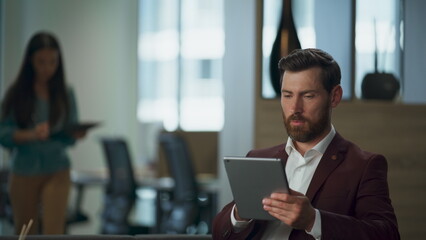 Focused partners reading documents tablet at office closeup. Lady showing papers