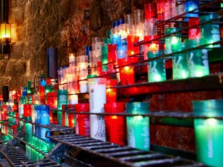 Candles in the Santa Maria de Montserrat Abbey, Montserrat, Monistrol de Montserrat, Barcelona, Spain - obrazy, fototapety, plakaty