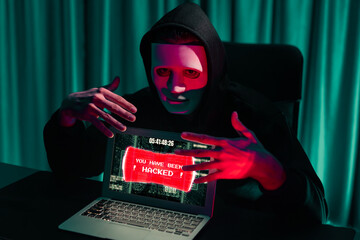 Criminal anonymous mask successful making password encryption by programming hack on laptop of...
