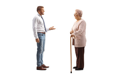 Professional man in jeans and white shirt standing and talking to an elderly woman