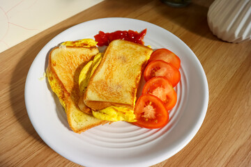 Simple breakfast menu, bread toast with egg and tomato