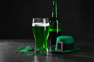 St. Patrick's day celebration. Green beer, leprechaun hat and decorative clover leaves on grey table