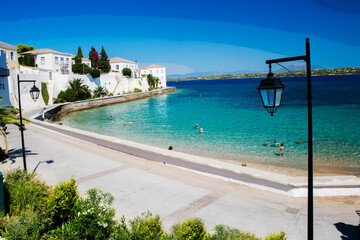 Amazing View on  Spetses - one of fantastic of Greek islands and   outdoors chairs and umbrellas of white and blue color