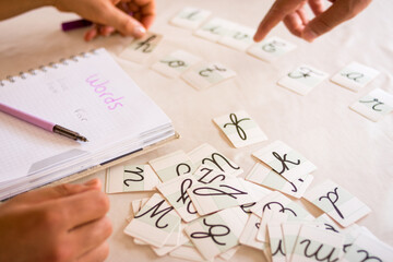 Teaching languages  with some cards and writing on notebook - obrazy, fototapety, plakaty