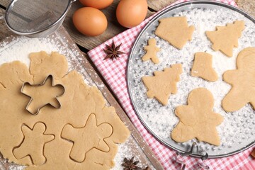 Making Christmas cookies. Flat lay composition with ingredients and raw dough on wooden table