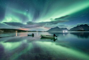 Small (Aurora borealis) motorboats anchoring in a bay, night view, starry sky, northern lights Northern Lights, Straumen, Nordland, Norway, Europe