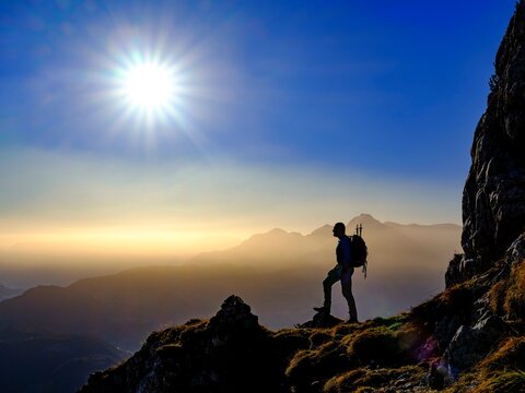 Silhouette of a mountaineer on an exposed path in the morning sun, in the background Hoher Goell, Grubenpfad, Untersberg, Berchtesgadener Alpen, Marktschellenberg, Berchtesgadener Land, Upper