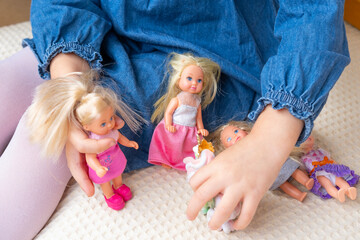 girl, child plays mother-daughters with miniature dolls, Examining the cognitive benefits of...