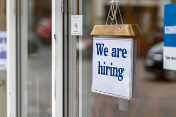 We are hiring sign in a shop or office window