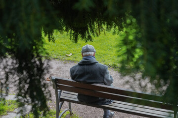 Old and lonely man sitting on a bench