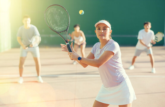 Latin woman playing frontenis on outdoor pelota court during training. Woman playing Basque pelota speciality.