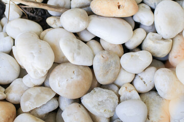 White stone in garden. Abstract minimal studio. Texture of white stones or gravel. Background and wallpaper.