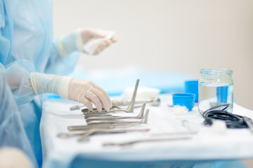 A nurse hands surgical instruments to a doctor during maxillofacial surgery operation. Sterile medical tools - 757634088