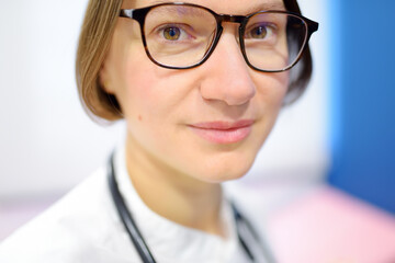 Close up portrait of young female doctor cardiologist during appointment of patient. Cardiology...
