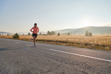 Fototapeta premium Determined Dawn: Confident and Motivated Athlete Embarks on Sunrise Run.