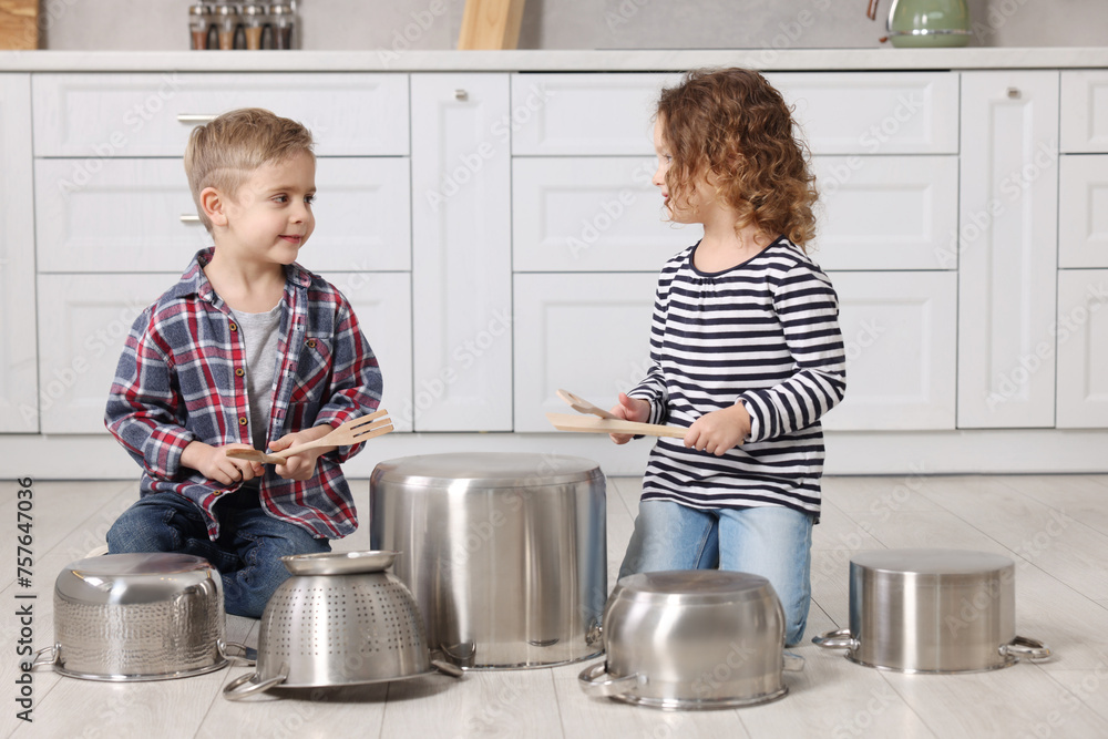 Canvas Prints Little children pretending to play drums on pots in kitchen