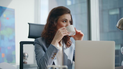 Businesswoman enjoy coffee break sitting office desk closeup. Calm lady drinking