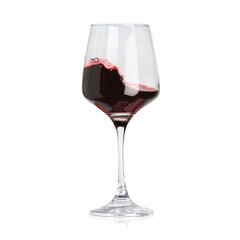 Red wine splashing in glass on white background